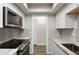 Modern kitchen showcases stainless steel appliances, marble countertops, and bright white cabinets with lots of space at 534 E 7Th Ave # 206, Denver, CO 80203