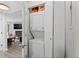 Convenient laundry room with stacked washer and dryer, adjacent to the living room with a fireplace at 534 E 7Th Ave # 206, Denver, CO 80203
