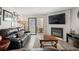 Inviting living room with a fireplace, large leather couch, and glass sliding doors to the outdoor seating area at 534 E 7Th Ave # 206, Denver, CO 80203