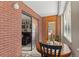 Cozy brick-walled patio with a round wooden table, with an entrance to the living room at 534 E 7Th Ave # 206, Denver, CO 80203