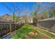 Large backyard featuring a fire pit, mature trees, and a wooden fence providing privacy at 2109 Jackson St, Golden, CO 80401