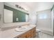 Functional bathroom featuring a double sink vanity, tile flooring, and a shower-tub combination at 2109 Jackson St, Golden, CO 80401