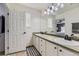 Clean bathroom with double sinks, white cabinets, and a large mirror at 9544 Longford Way, Parker, CO 80134