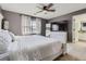 Comfortable bedroom featuring a large window, ceiling fan, and ensuite bathroom at 9544 Longford Way, Parker, CO 80134