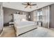 Relaxing bedroom with a large window, a ceiling fan, and a soothing color palette at 9544 Longford Way, Parker, CO 80134