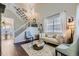 Elegant living room featuring high ceilings, a staircase, and refined decor with lots of natural light at 9544 Longford Way, Parker, CO 80134