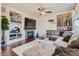 Cozy living room features built-in shelves, a fireplace, and a comfortable sectional sofa at 9544 Longford Way, Parker, CO 80134