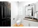 Modern bathroom with a white vanity and dark-framed mirror at 6307 E 141St Ln, Thornton, CO 80602