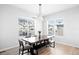 Light-filled dining room with a live-edge wood table and bench seating at 6307 E 141St Ln, Thornton, CO 80602