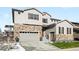 Two-story house with stone accents and a two-car garage at 6307 E 141St Ln, Thornton, CO 80602