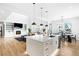 Modern kitchen island with white cabinets and stainless steel appliances at 6307 E 141St Ln, Thornton, CO 80602