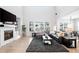 Living room with a modern fireplace and large sectional sofa at 6307 E 141St Ln, Thornton, CO 80602