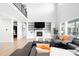 Living room with a modern fireplace and built-in shelving at 6307 E 141St Ln, Thornton, CO 80602