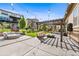 Spacious backyard featuring a pergola, gas fire pit, cabana, and lush landscaping at 2134 S Poppy St, Lakewood, CO 80228