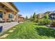 Beautiful backyard with lush green grass, stone patio, and outdoor seating area, perfect for entertaining guests at 2134 S Poppy St, Lakewood, CO 80228