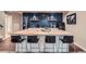 Stylish basement bar featuring wood countertop, blue paneling, and modern lighting at 2134 S Poppy St, Lakewood, CO 80228