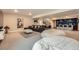 Spacious finished basement with lounge area, bar, and comfortable seating at 2134 S Poppy St, Lakewood, CO 80228