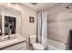 Small bathroom featuring vanity sink, toilet, and tiled shower with curtain at 2134 S Poppy St, Lakewood, CO 80228