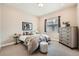 Relaxing bedroom featuring neutral tones, comfortable bed, and dresser at 2134 S Poppy St, Lakewood, CO 80228