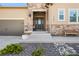 Close-up of the home's entrance, featuring a decorative stone accent wall and a cozy bench at 2134 S Poppy St, Lakewood, CO 80228