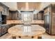 Spacious kitchen with a granite countertop island, stainless steel appliances, and rich wood cabinets at 2134 S Poppy St, Lakewood, CO 80228