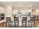 Well-appointed kitchen with a large island, pendant lighting, and stainless steel appliances at 2134 S Poppy St, Lakewood, CO 80228