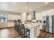 Modern kitchen showcasing a large island, stylish bar stools, and stainless steel appliances at 2134 S Poppy St, Lakewood, CO 80228