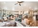 Open-concept living area with hardwood floors, modern decor, and seamless flow to the kitchen at 2134 S Poppy St, Lakewood, CO 80228