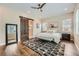 Serene bedroom featuring a sliding barn door to the en-suite bathroom and a cozy seating area at 2134 S Poppy St, Lakewood, CO 80228