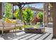 Outdoor patio with a pergola, comfortable seating, and a modern gas fireplace at 2134 S Poppy St, Lakewood, CO 80228