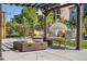 Relaxing backyard patio area with a pergola, comfortable seating, and a gas fire pit at 2134 S Poppy St, Lakewood, CO 80228