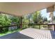 Covered backyard deck offers outdoor living space and overlooks a lush yard with a shed at 5898 Parfet Ct, Arvada, CO 80004