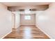 Bedroom featuring vinyl wood floors and window at 5898 Parfet Ct, Arvada, CO 80004