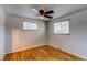 A bright bedroom featuring hardwood floors and dual windows at 5898 Parfet Ct, Arvada, CO 80004