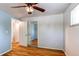 Bedroom with hardwood floors and a closet with mirrored doors at 5898 Parfet Ct, Arvada, CO 80004