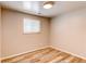 Bedroom featuring vinyl wood floors and window at 5898 Parfet Ct, Arvada, CO 80004