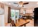 Eat-in kitchen features a wooden dining table and sliding glass doors leading to a deck at 5898 Parfet Ct, Arvada, CO 80004