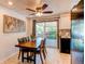 Bright eat-in kitchen area with a wooden table, tile floors, and a sliding door to the deck at 5898 Parfet Ct, Arvada, CO 80004