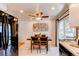 Inviting kitchen and dining area with a refrigerator, dining table, and a ceiling fan at 5898 Parfet Ct, Arvada, CO 80004