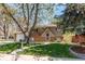 Charming two-story home featuring a well-manicured lawn and mature trees in a quiet neighborhood at 5898 Parfet Ct, Arvada, CO 80004
