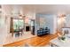 Inviting living and dining area with hardwood floors, modern lighting, and an open layout at 5898 Parfet Ct, Arvada, CO 80004