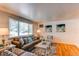 Bright living room featuring hardwood floors, a large window, and stylish decor at 5898 Parfet Ct, Arvada, CO 80004