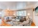 Cozy living room with hardwood floors, neutral walls, and ample natural light from large window at 5898 Parfet Ct, Arvada, CO 80004