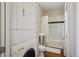 Bathroom with stackable washer/dryer, pedestal sink, tiled tub with shower at 1176 Gaylord St # 101, Denver, CO 80206