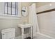 Bathroom featuring subway tile, pedestal sink, and tub with shower at 1176 Gaylord St # 101, Denver, CO 80206