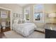 Inviting bedroom with white bedding, area rug and plenty of natural light at 1176 Gaylord St # 101, Denver, CO 80206