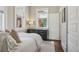 Comfortable bedroom with hardwood floors, dresser, and bright windows at 1176 Gaylord St # 101, Denver, CO 80206