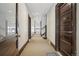Hallway with multiple doors leading to individual rooms, carpet flooring, and natural light at 1176 Gaylord St # 101, Denver, CO 80206