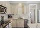 A well-appointed kitchen with white cabinets, marble countertops, and stainless steel appliances at 1176 Gaylord St # 101, Denver, CO 80206