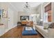 Comfortable living room with hardwood floors, accent wall, and stylish decor under a modern light fixture at 1176 Gaylord St # 101, Denver, CO 80206